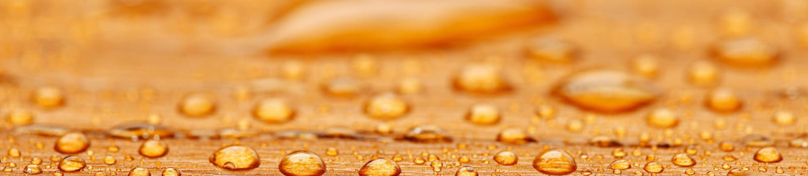 Water droplets from beeswax protected wood